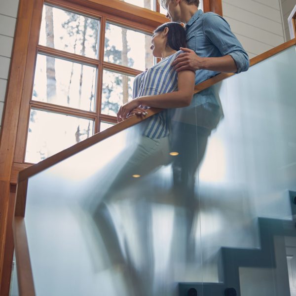 Low angle portrait of happy attractive family couple enjoying beautiful nature out the window